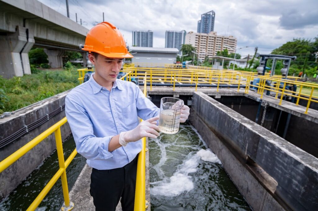 man inspecting waste water