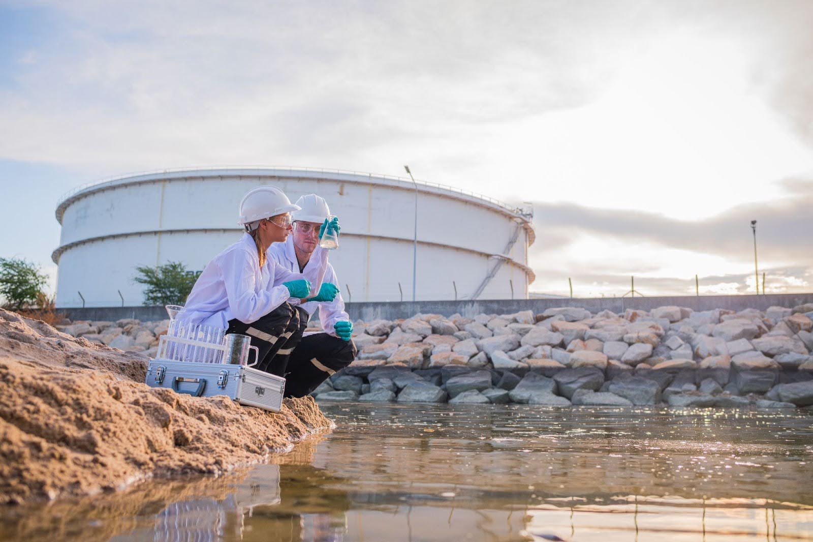 scientists testing water at industrial plant